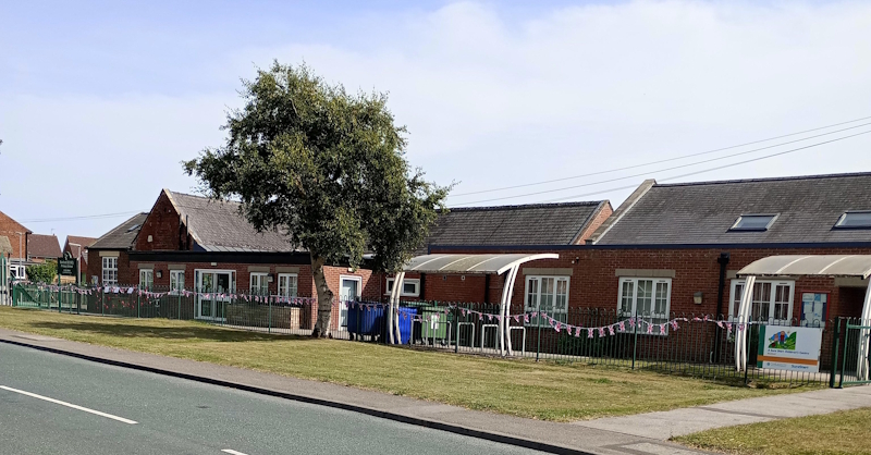 VJ Day 80th Anniversary, flags decorating the school railings